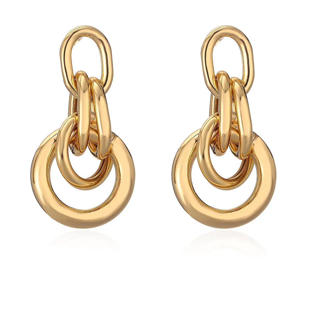 A pair of real gold coloured geometric earrings with an irregular shape, made from copper, style wild.