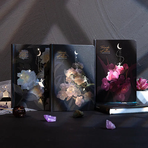 A5 notebook with a luminous cover open to show internal colour illustrations, next to Purple, Light Blue, Gold, and Deep Blue colour options.