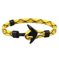 Anchor bracelet with black cotton linen rope and brass alloy anchor charm on white background