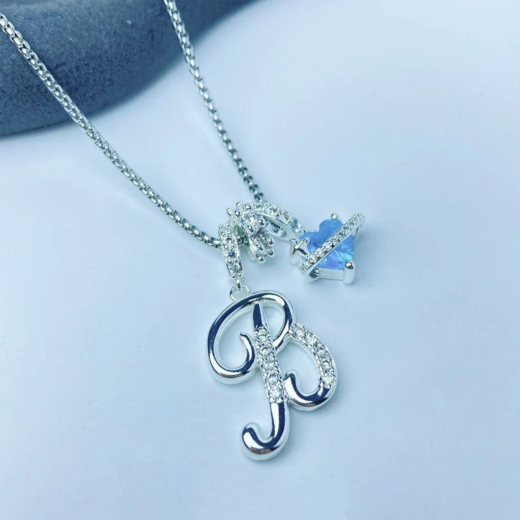 Copper English letter necklace with 26 alphabet charms in gold and silver style on display