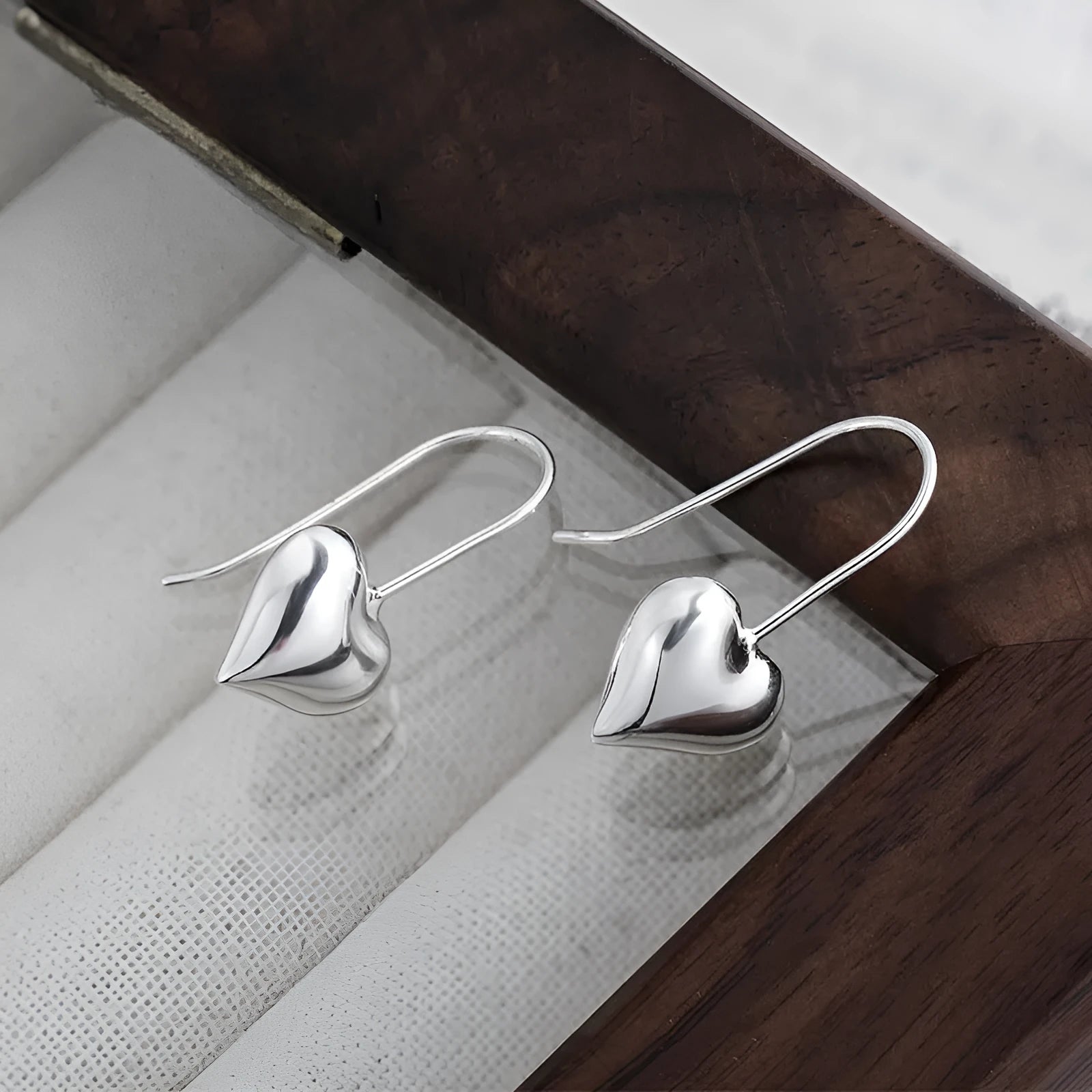 Three-dimensional glossy heart-shaped earrings with white gold colour finish and Korean-style design