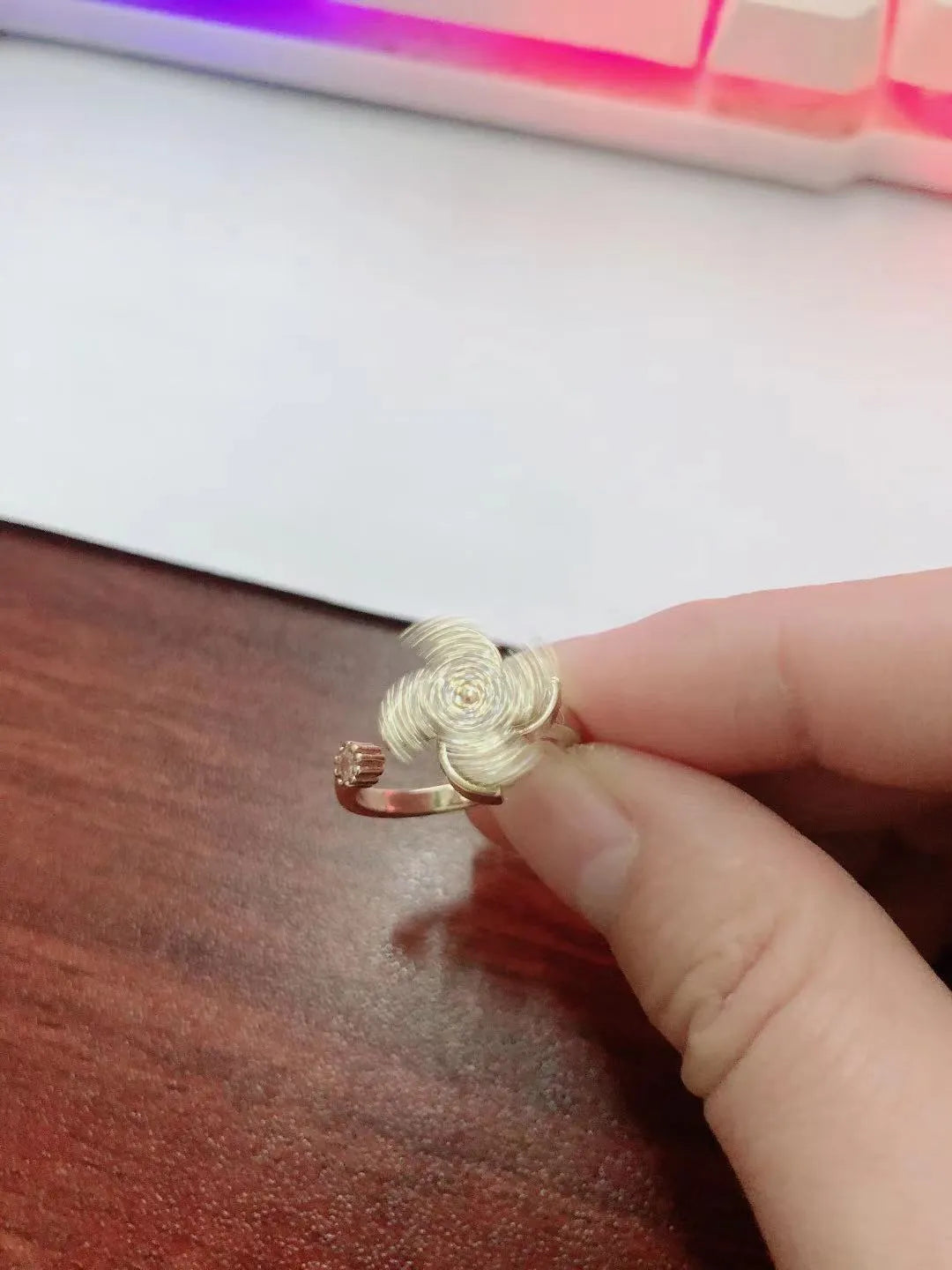 Micro rotating ring with spinning windmill centrepiece in gold or silver finish