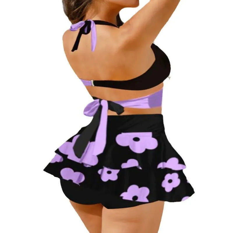 Women's purple bikini swimsuit with matching skirt showing high-waisted lace-up back design