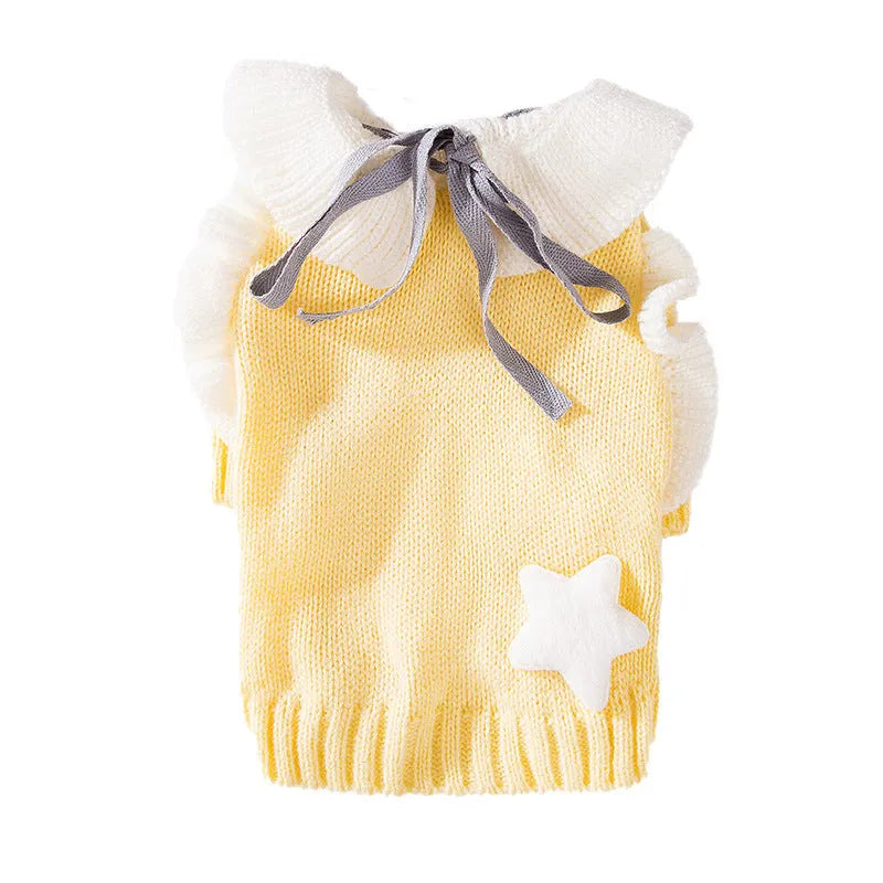 Yellow knitted dog sweater with star pattern and turtleneck on small breed puppy