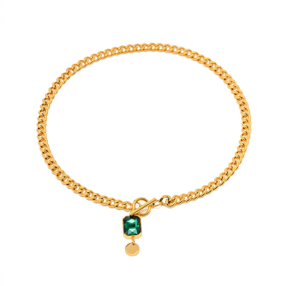 Gold coloured geometric zircon pendant necklace on a Cuban link chain for women.