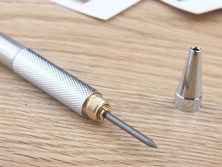 Metal automatic mechanical pencil on a surface, shown with multiple lead size indicators including 0.5mm and 2.0mm.