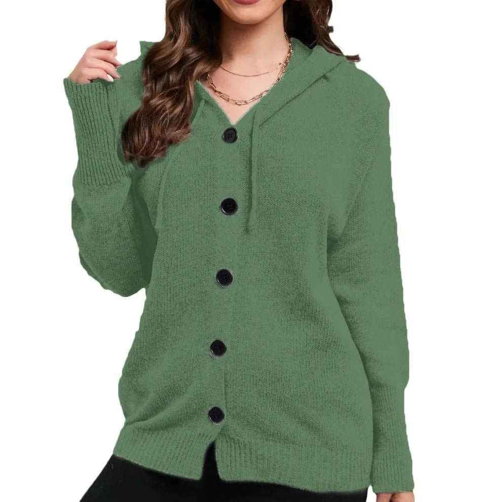 Woman wearing a thick army green zip-up hooded cardigan sweater with a loose fit.