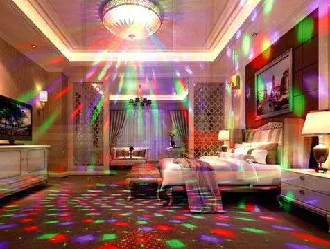 Black and white LED laser magic fan stage light with remote control on a dark background.