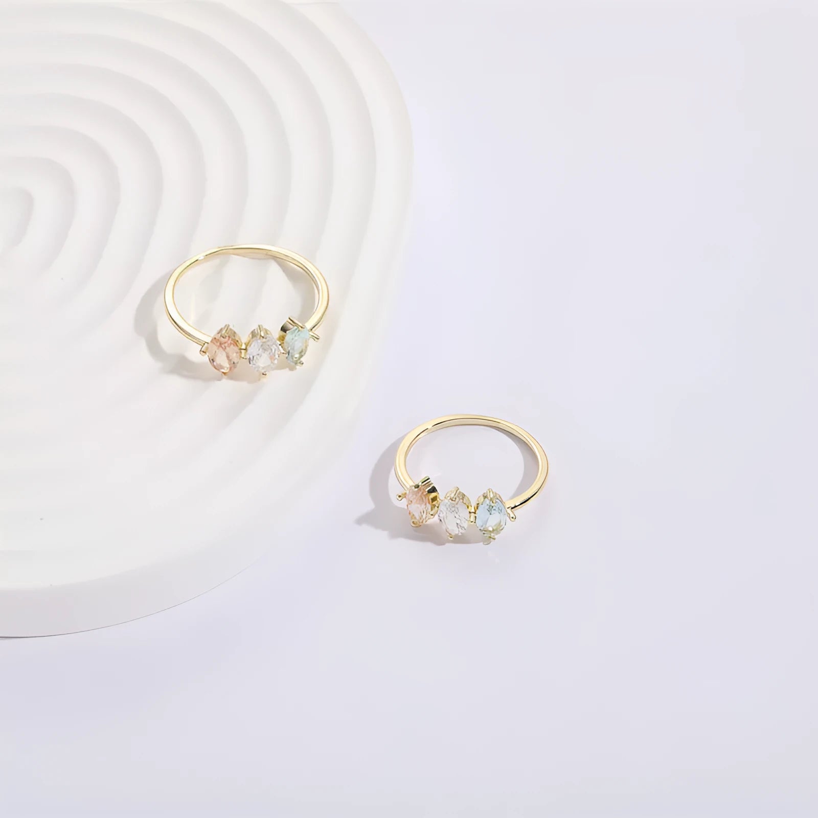 Geometric triangle women's ring with tricolor zircon horse eye design in electroplated gold.