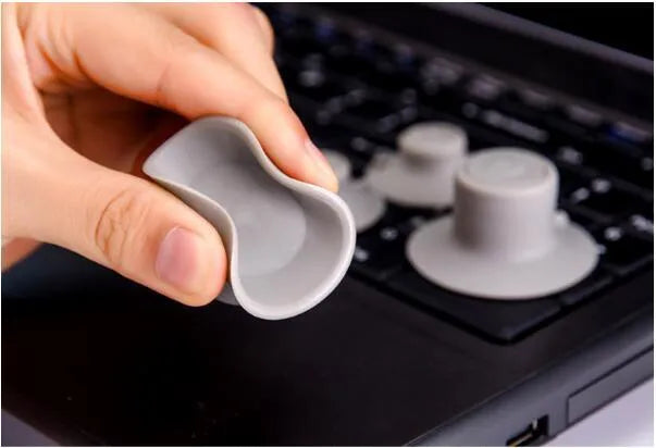 Four grey durable plastic laptop cooling pads shown in two different sizes on a table