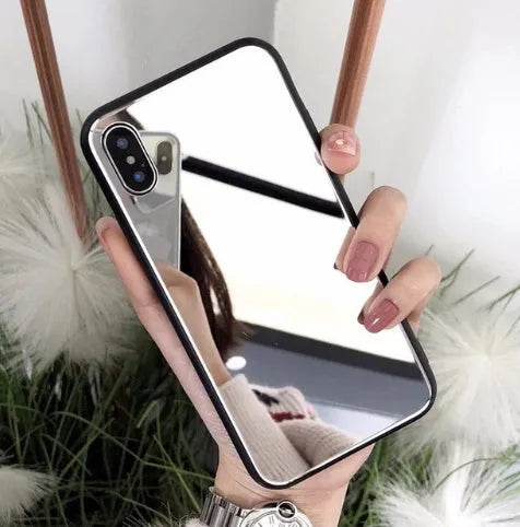 Black mirrored back cover phone case for Apple iPhone models on a table.