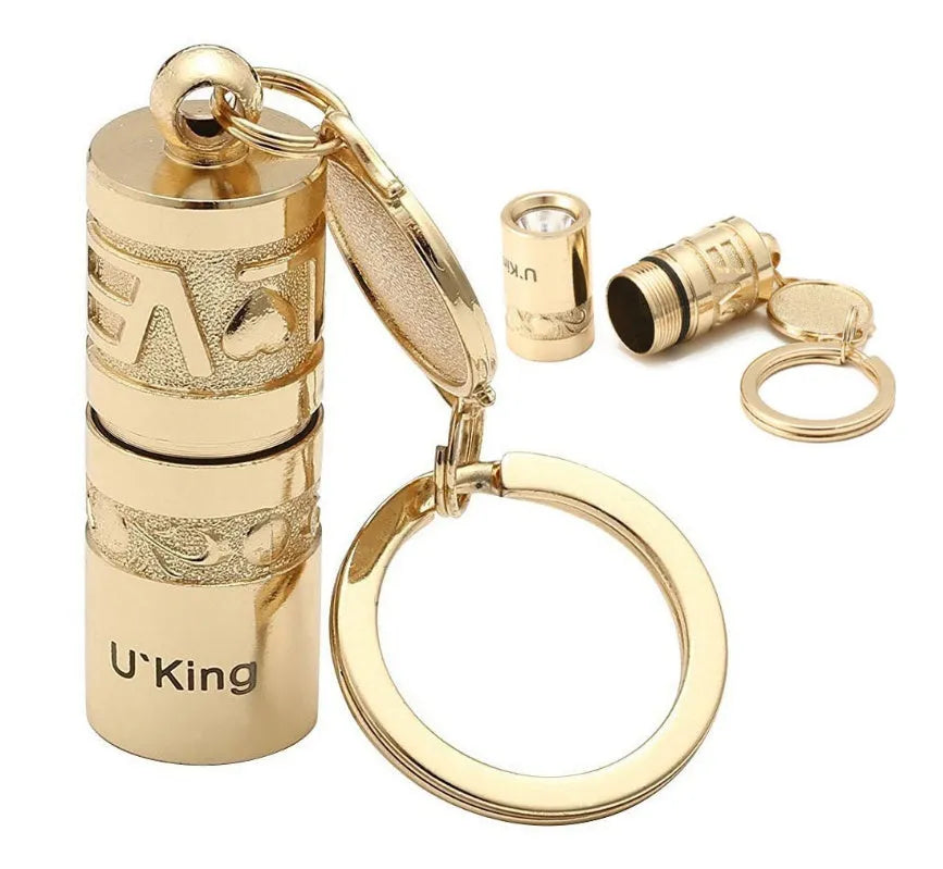 Gold zinc alloy waterproof mini LED flashlight attached to a keychain ring.