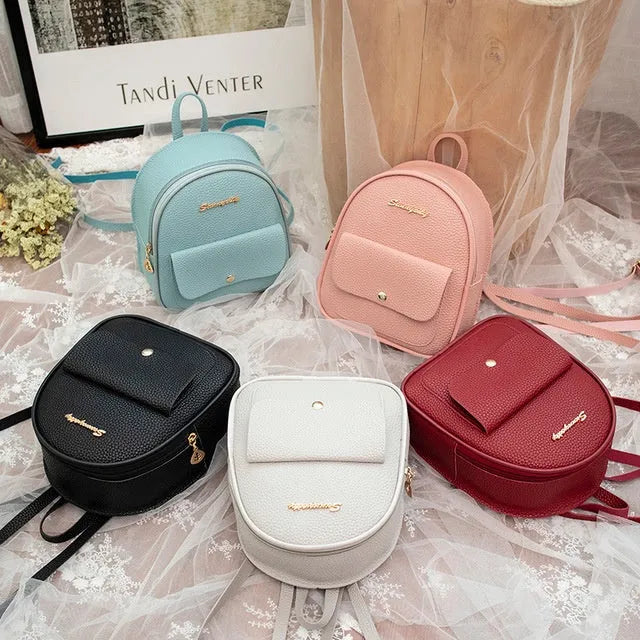 Compact black PU women's shoulder bag also worn as a small backpack, showing zipper closure.