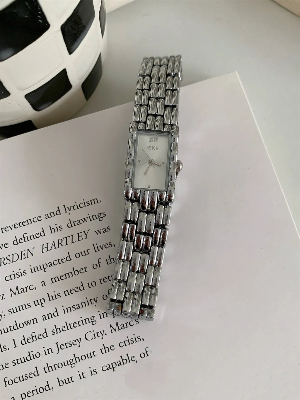 Women's bracelet-style watch with 15mm dial, mineral glass, and butterfly buckle in silver or gold finishes