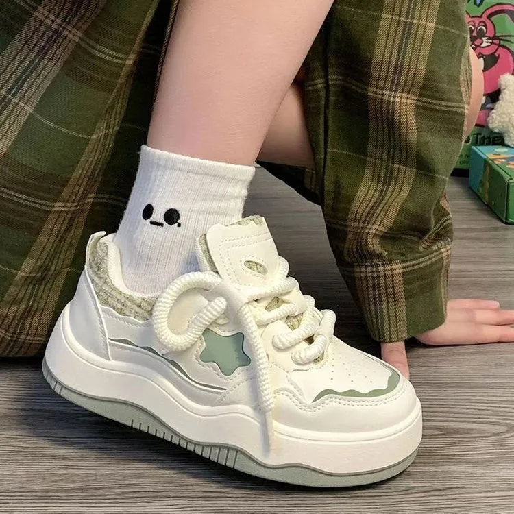 Women's green patent leather platform sneaker with front lace-up design and round toe