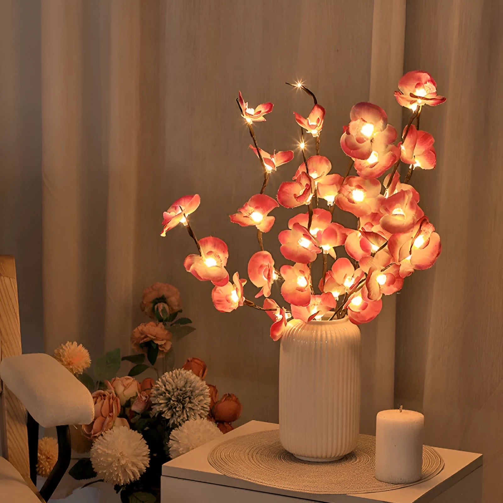 Pink LED phalaenopsis orchid branch decorative light, 65 cm tall, on a table.