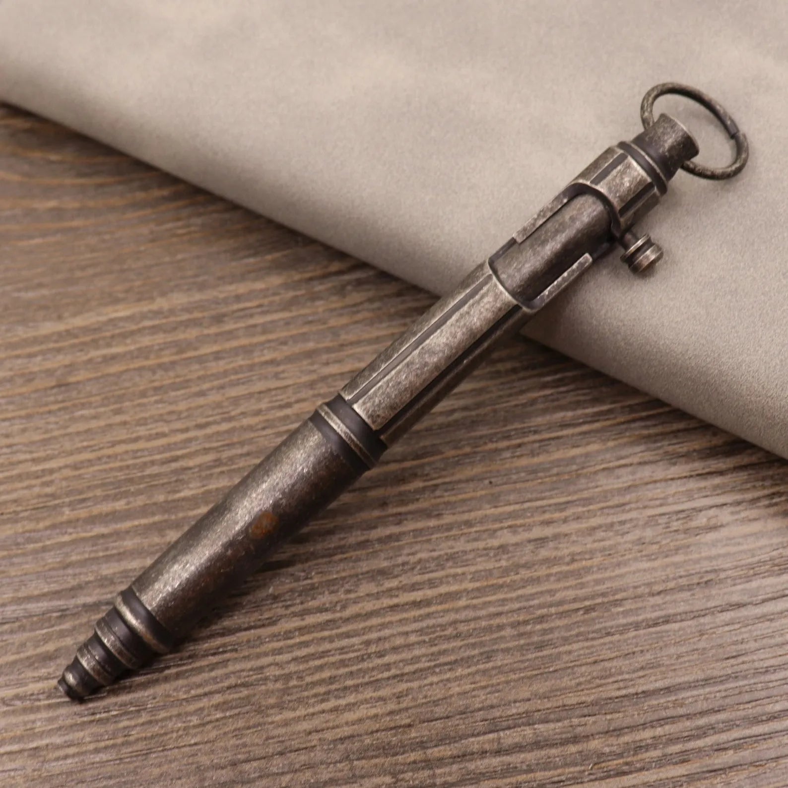 Retro brass tactical pen with press bolt-action mechanism and cylindrical metal barrel