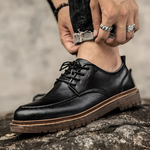 Casual leather shoes in black with round toe, low top design, and visible sewing line detailing