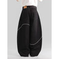 Men's black straight-leg denim trousers with a zip fly on a mid waist, shown in a casual street style.