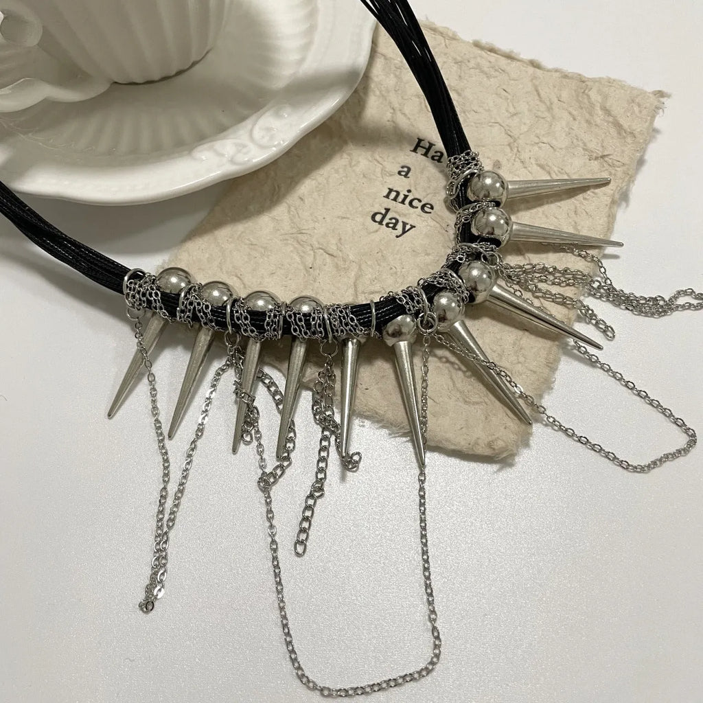Women's casual leather necklace with round beads, a winding tassel, and decorative rivet details in an electroplated finish.