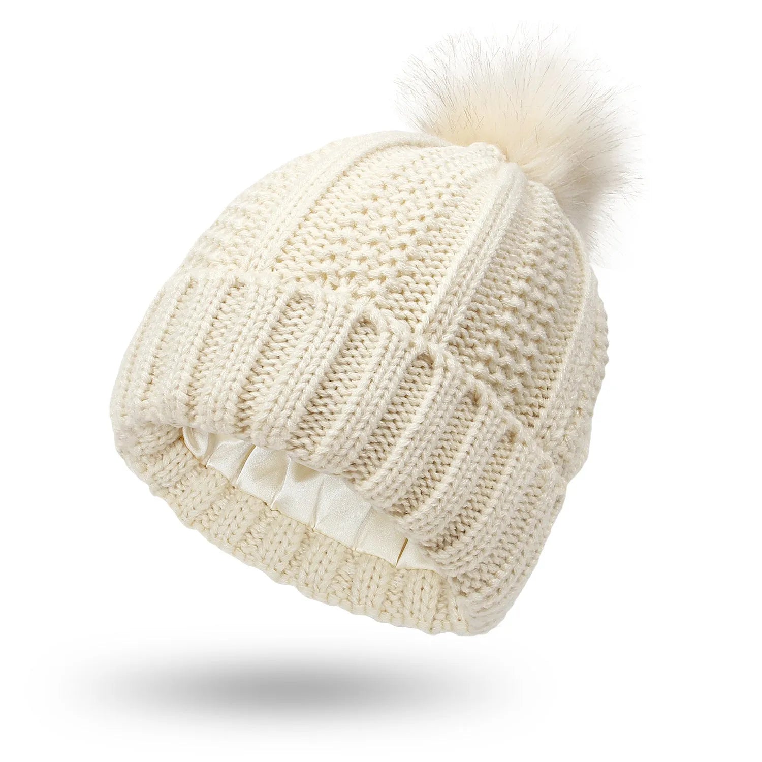 Woman wearing a light grey wool beanie with a faux fur pom pom and satin lining.