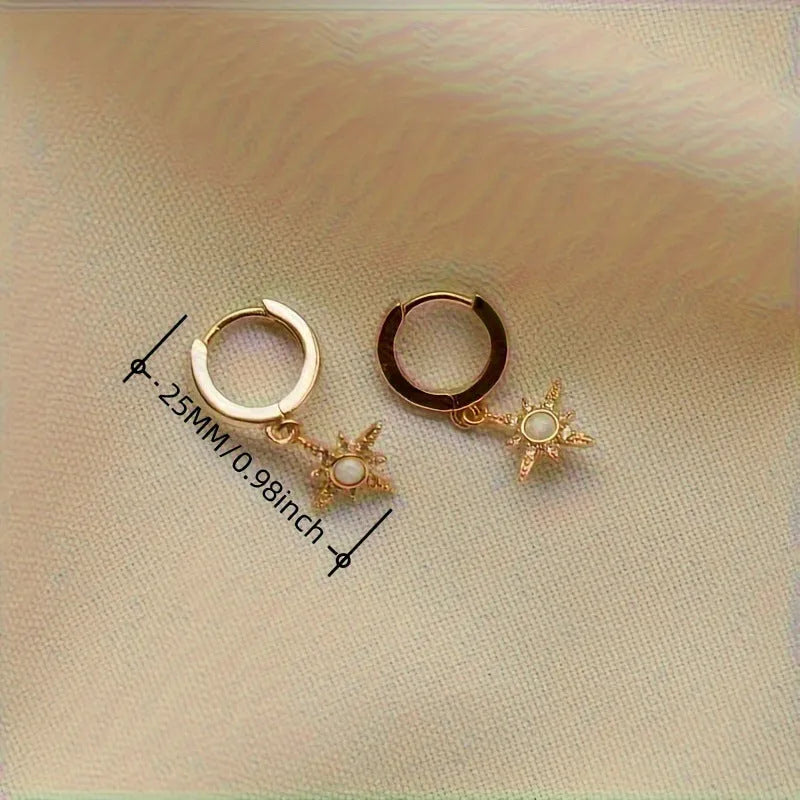 Gold copper eight-pointed star opal stud earrings on a white background