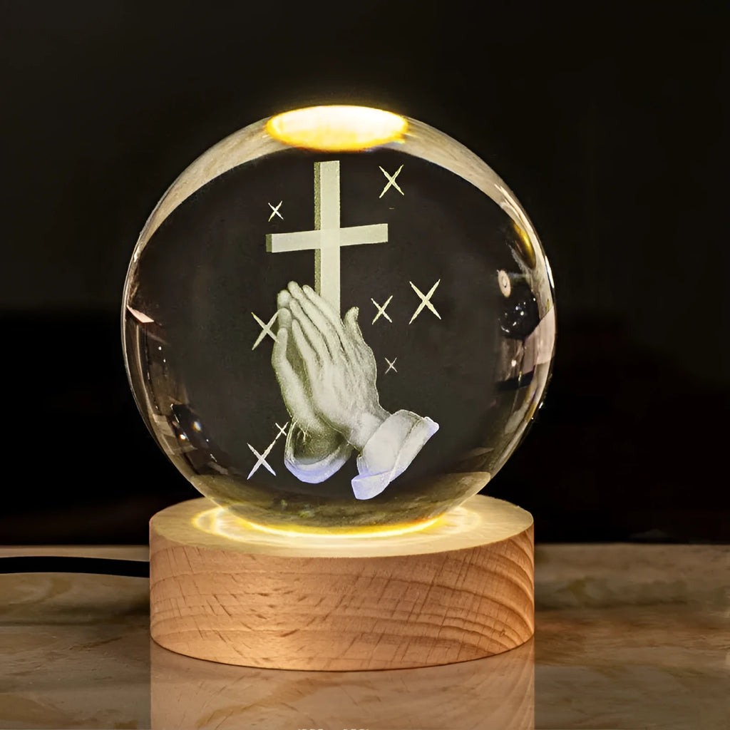 White crystal ball with cross and religious symbols on wooden LED base desk ornament