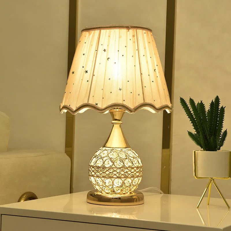 Gold crystal desk lamp with iron art base and remote control on wooden table