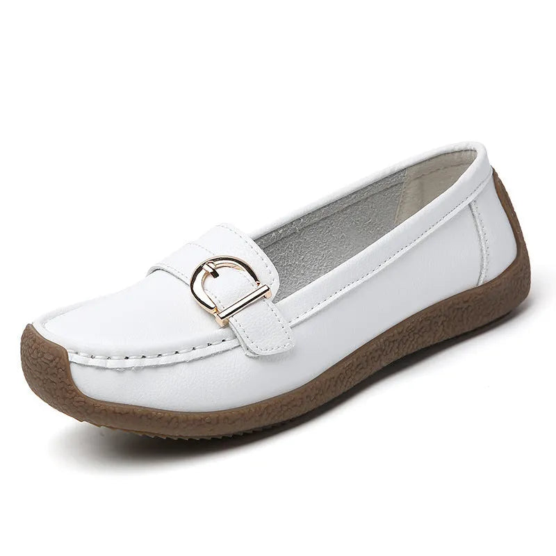 Women's beige loafers with round toe and flat heel on a light background