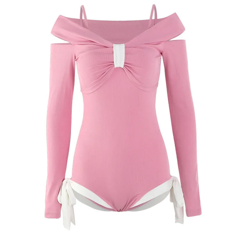 Women's long sleeve one-piece swimsuit in pink and black, made from polyester fabric.