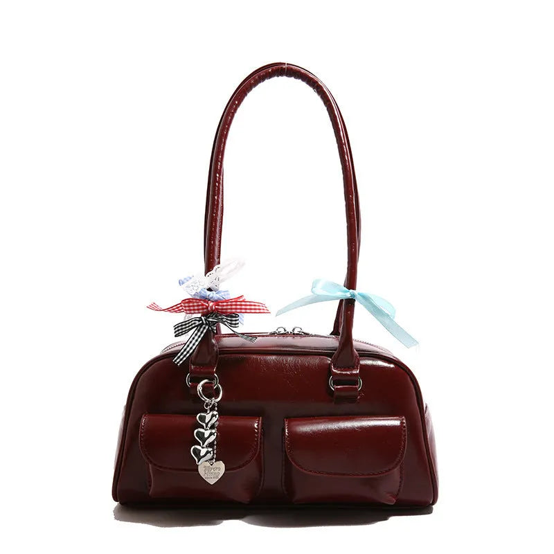 Retro brown PU leather women's pillow handbag with a flap and double shoulder strap on a neutral background.