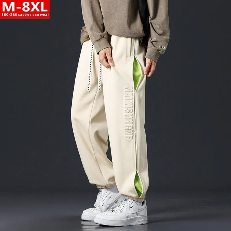 Men's loose fit cotton trousers with banded ankles and stitching details in grey green colour