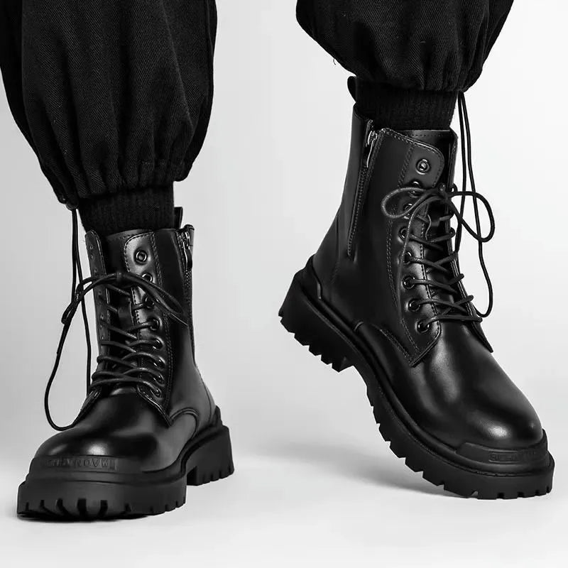 Men's black mid-top British leather boots with flat rubber sole on a neutral background