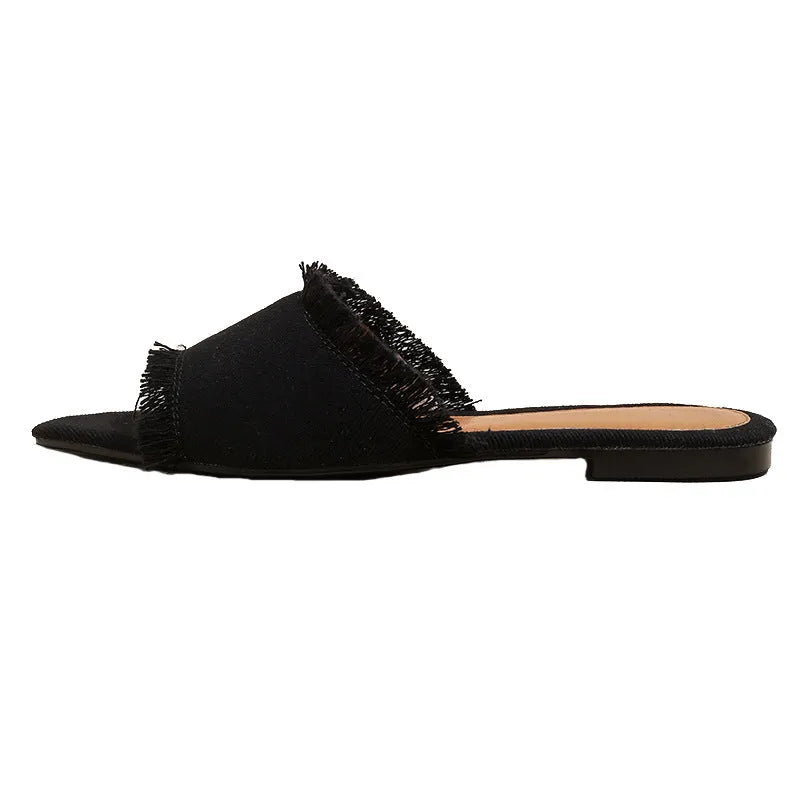 Women's denim flat slippers with tassel detail and leather lining in multiple colours.