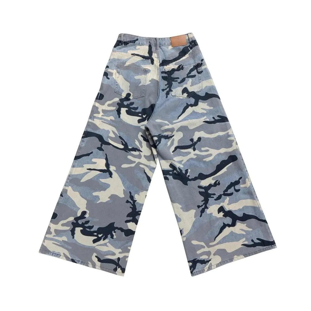 Snow camouflage pattern on blue loose-fit denim jeans with a mid waist.
