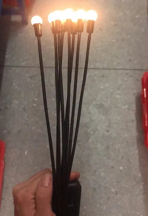 Solar-powered LED ground spike garden light with multiple heads and stainless steel soil plug.
