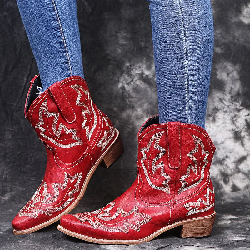 Blue women's cowboy ankle boots with embroidery, a pointed toe, and a low wedge heel.