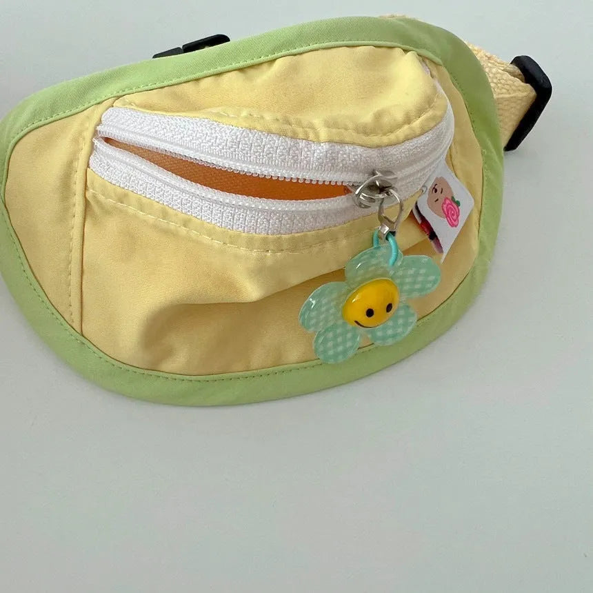 Powder blue backpack-style dog poop bag dispenser clipped to a harness.