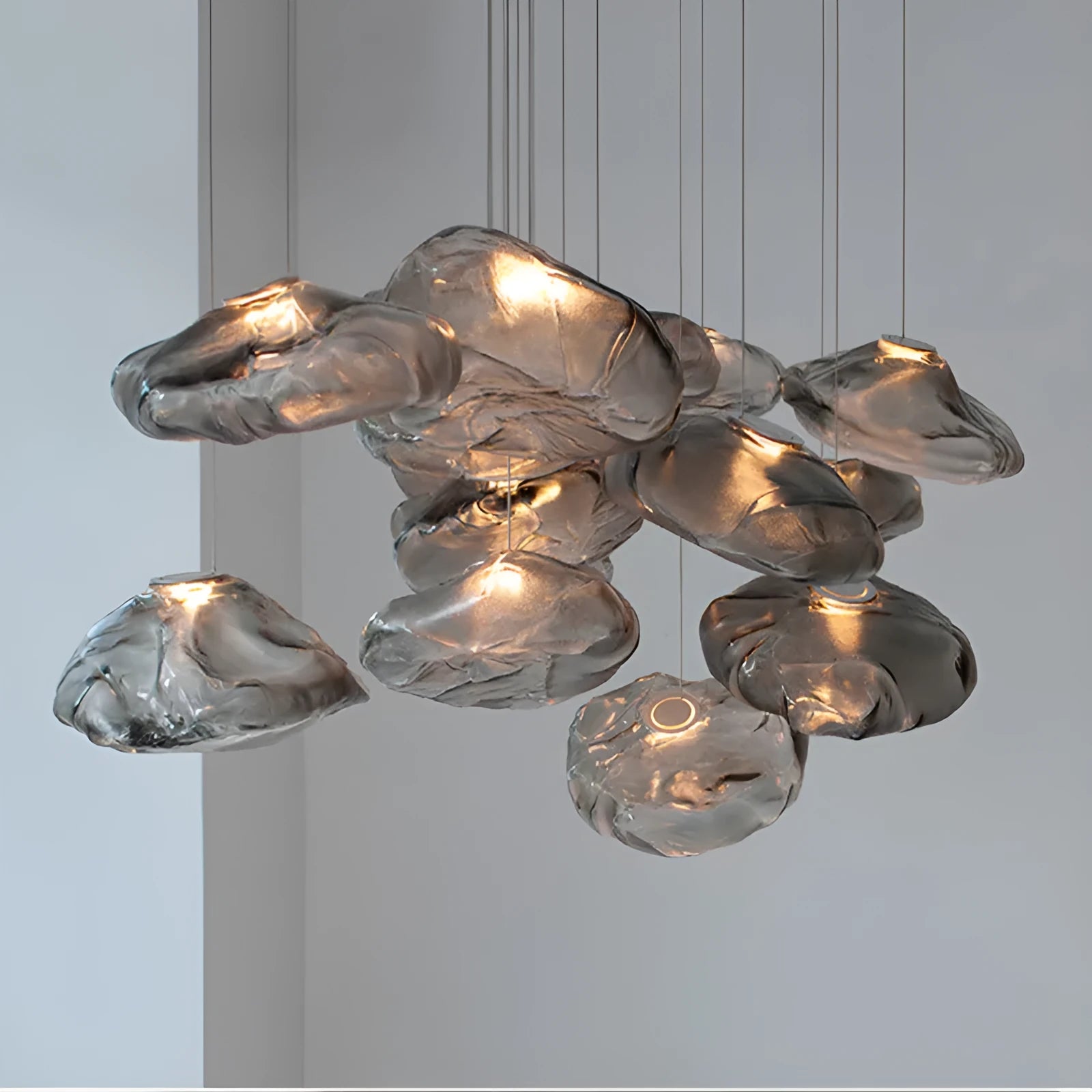 Modern fabric chandelier with glass shade shown in small and large sizes with clear, amber, and smoke grey light options.