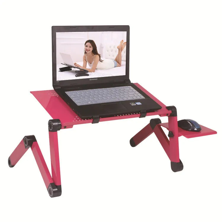 Black folding metal laptop bed table with cooling fans extended over a sofa