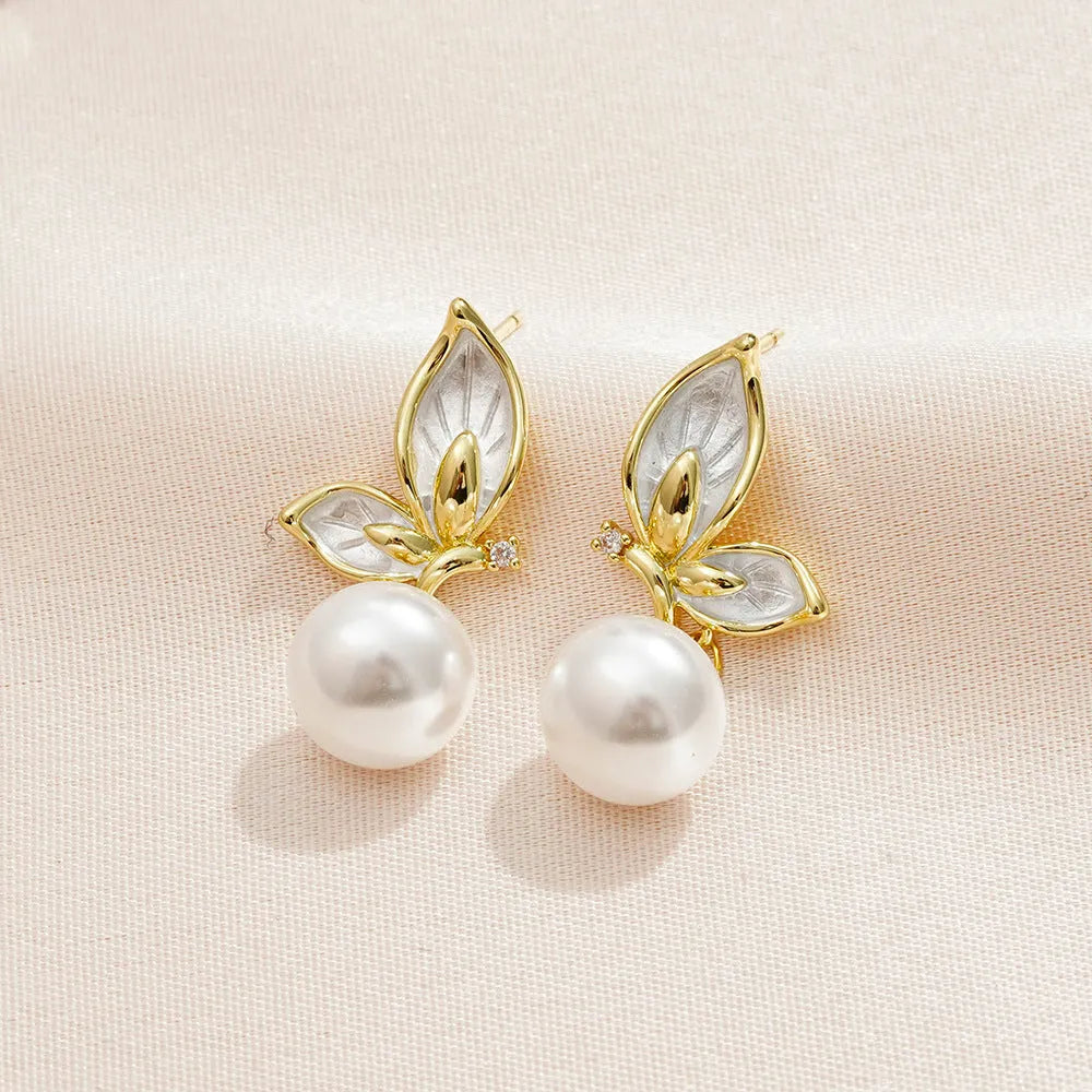 Pair of simple style butterfly earrings for women with electroplated copper construction.