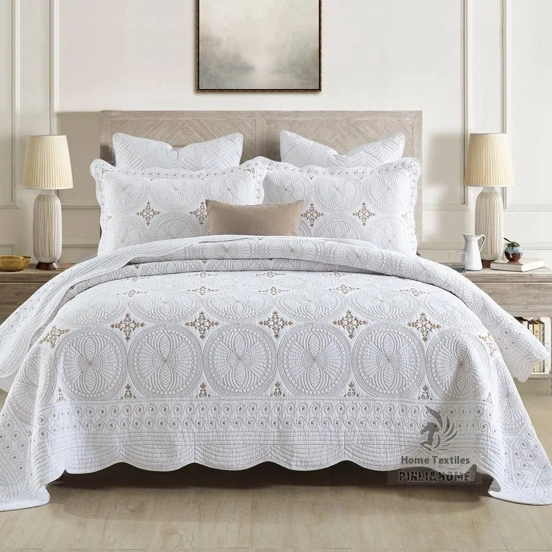 Double thick pure cotton European-style embroidered bed cover set with two pillowcases on a bed.