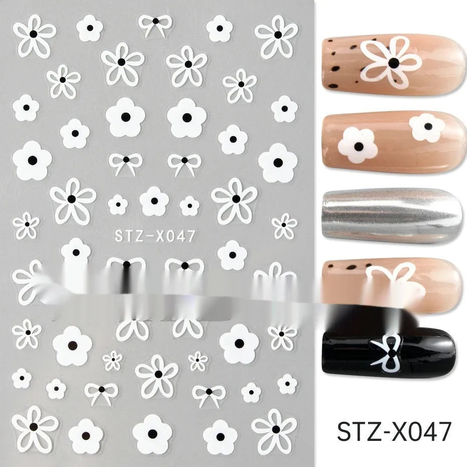 Sheet of black and silver love heart pattern nail art stickers with a plastic nail patch.