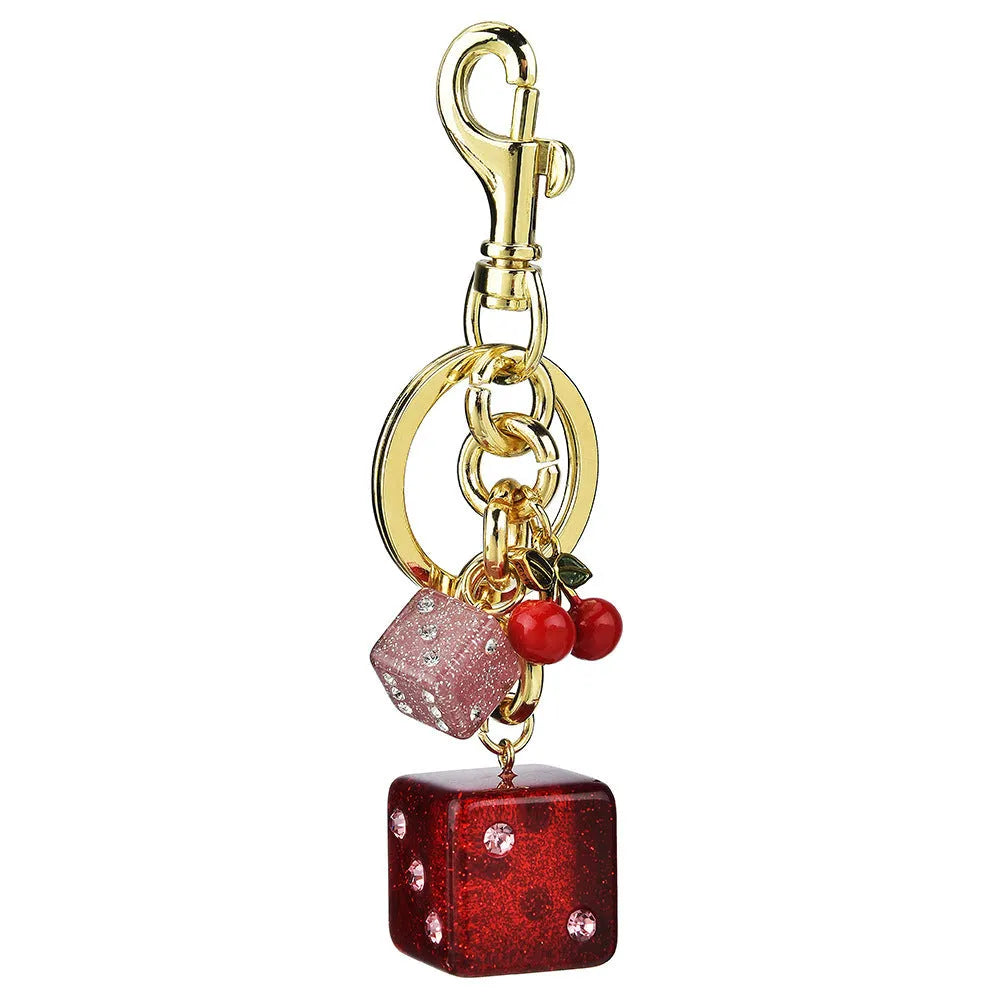 Square metal keychain pendant with a vintage two-tone cherry dice pattern on a white background.