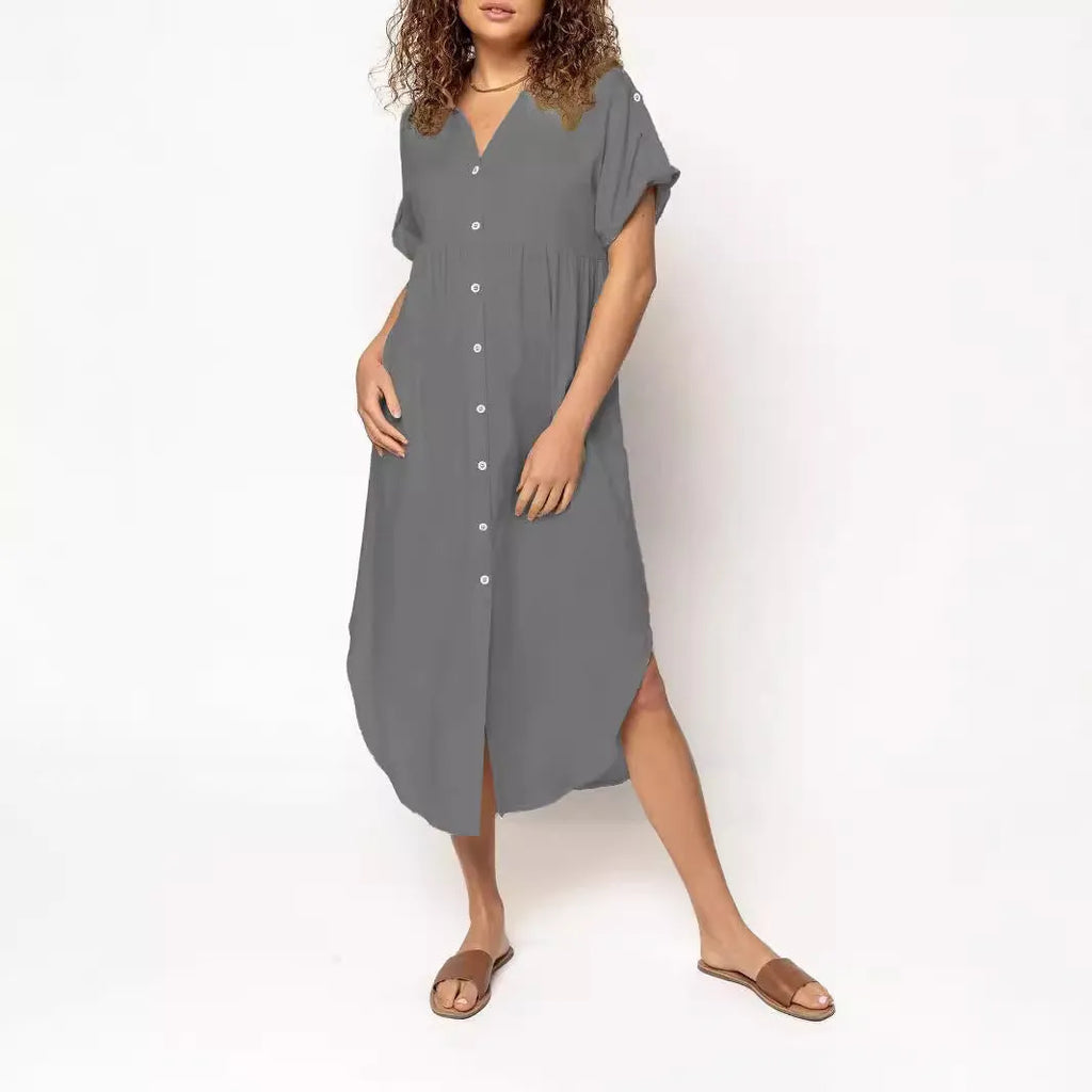 A woman wearing a casual solid-colour mid-length dress with a button-down front.