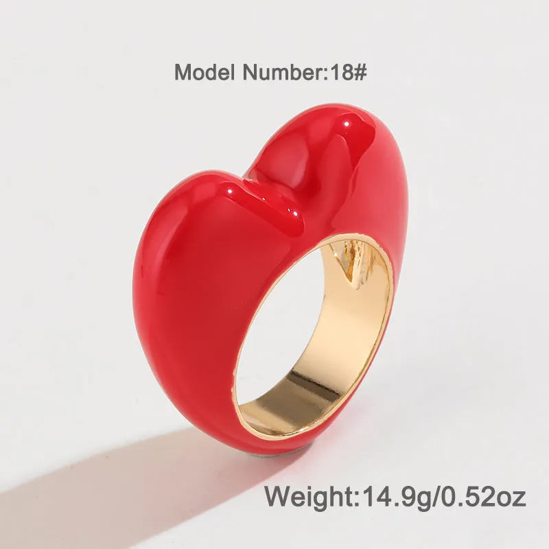 A heart-shaped three-dimensional enamel ring in zinc alloy, shown in one of four available colours.