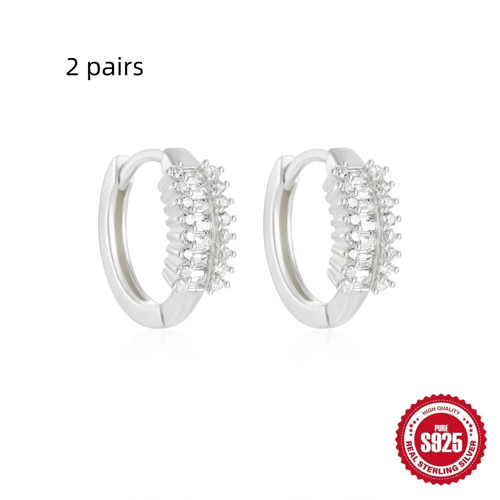 Sterling silver geometric stud earrings with small round design elements in gold or silver finish