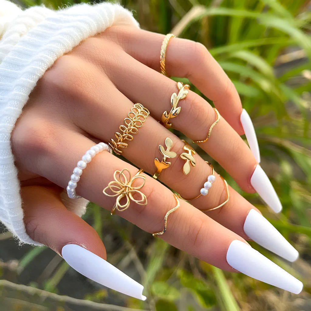 Gold openwork flower ring set showing floral design and glossy electroplated finish