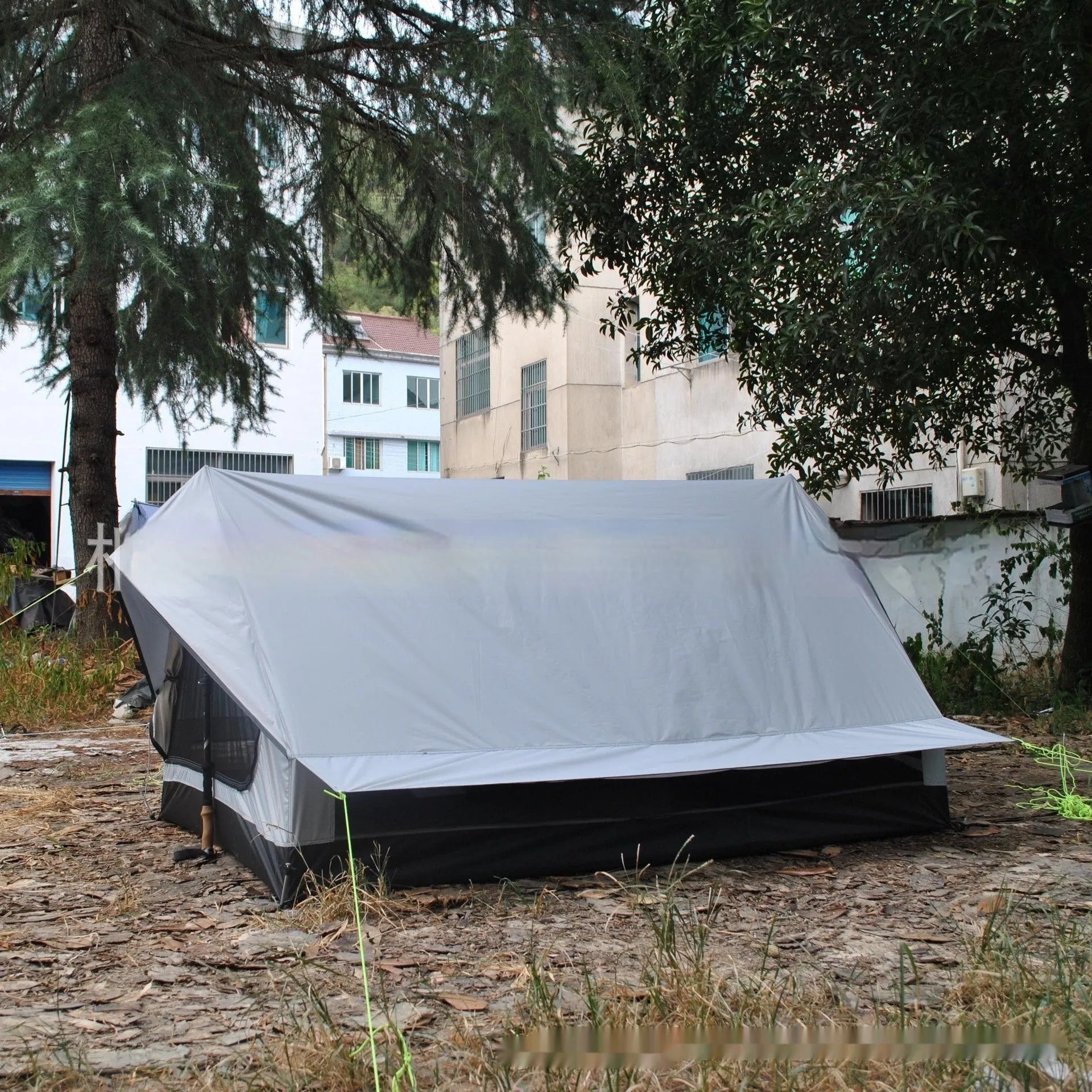 Brown or white A-line cabin tent using hiking canes for support with dimensions 210x150x110cm