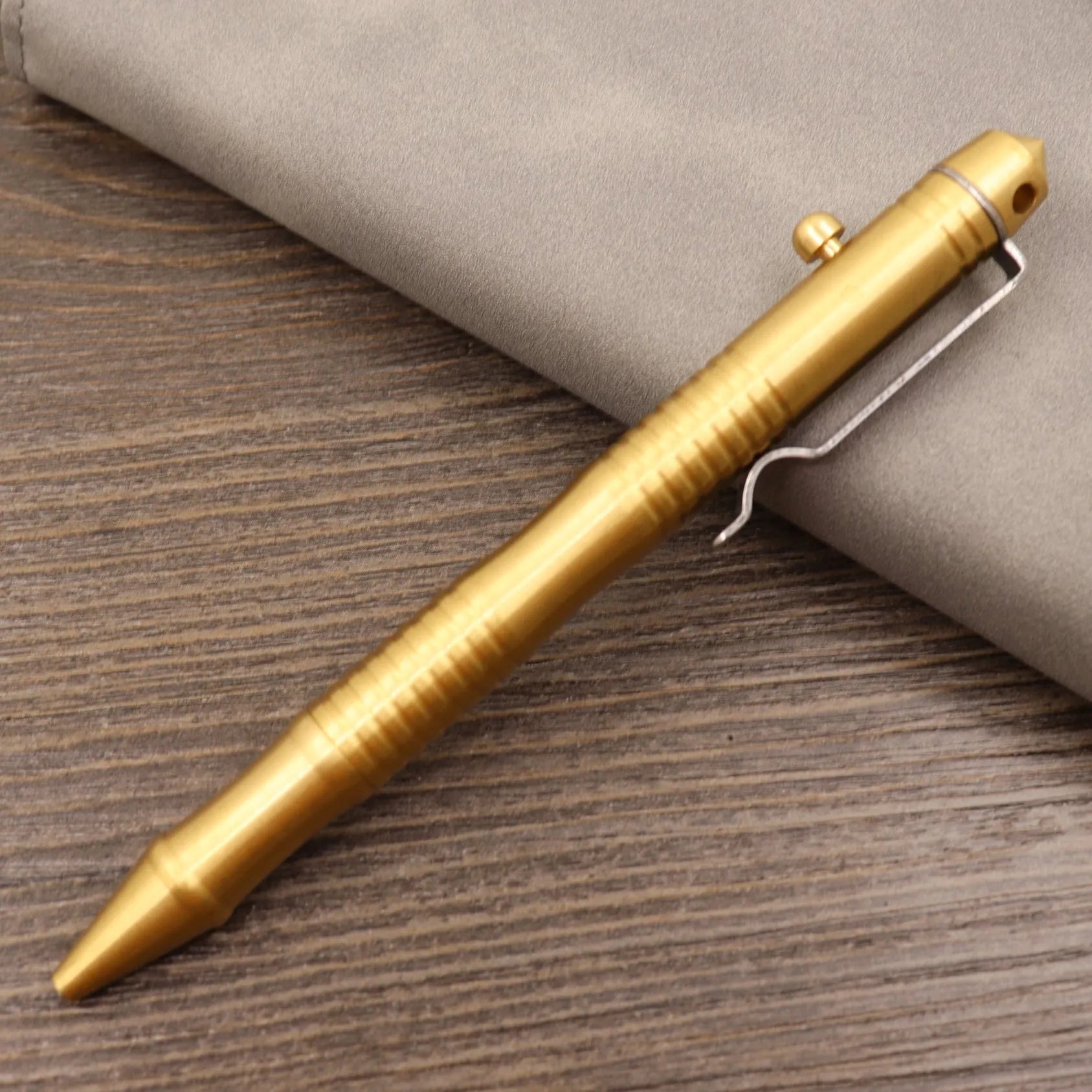 Retro brass tactical pen with press bolt-action mechanism and cylindrical metal barrel